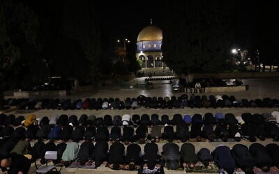Palestinian Muslim worshipers perform Taraweeh prayers on the first night of the Muslim holy month of Ramadan near the Dome of the Rock Shrine at the Al-Aqsa mosque compound atop the Temple Mount, in the Old City of Jerusalem on February 17, 2026. (AHMAD GHARABLI / AFP)
