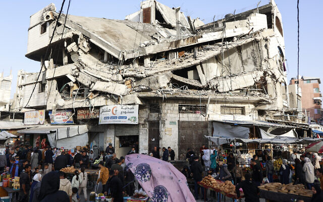 Palestinians shop for food beneath a destroyed building in Gaza City's Zawiya market on February 18, 2026, on the first days of the month of Ramadan. (Omar AL-QATTAA / AFP) Palestinians shop for food beneath a destroyed building in Gaza City's Zawiya market on February 18, 2026, on the first days of the month of Ramadan. (Omar AL-QATTAA / AFP)