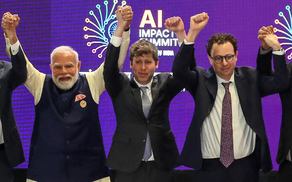 India's Prime Minister Narendra Modi (left) takes a group photo with AI company leaders including OpenAI CEO Sam Altman (center) and Anthropic CEO Dario Amodei (right) at the AI Impact Summit in New Delhi on February 19, 2026. (Ludovic MARIN / AFP)