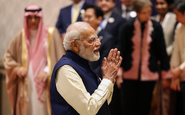 India's Prime Minister Narendra Modi gestures as he gathers with world leaders and representatives for a group photo during the AI Impact Summit in New Delhi on February 19, 2026. (Ludovic MARIN / AFP)