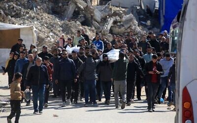 Palestinian men carry the bodies of two people killed in an IDF strike in Khan Younis, in the southern Gaza Strip, on February 27, 2026. (Bashar TALEB / AFP)