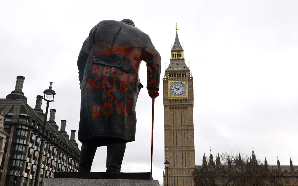 Graffiti reading 'Never again is now' is pictured on a statue of Britains former prime minister Winston Churchill in Parliament Square, in central London on February 27, 2026. (Brook Mitchell / AFP)