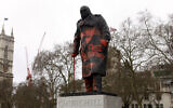 Graffiti, including the words 'Free Palestine' and several inverted triangles -- a symbol used in Hamas propaganda to indicate an Israeli target -- is seen on a statue of Winston Churchill, in central London on February 27, 2026. (Brook Mitchell / AFP)