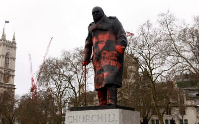 Graffiti, including the words 'Free Palestine' and several inverted triangles -- a symbol used in Hamas propaganda to indicate an Israeli target -- is seen on a statue of Winston Churchill, in central London on February 27, 2026. (Brook Mitchell / AFP)