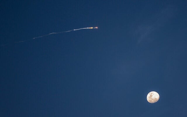 The moon is pictured before rocket trails from an interception over central Israel on February 28, 2026. (Photo by Jack GUEZ / AFP) The moon is pictured before rocket trails from an interception over central Israel on February 28, 2026. (Photo by Jack GUEZ / AFP)
