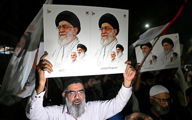 Pakistani Shiite Muslims hold posters of Iran's supreme leader Ayatollah Ali Khamenei to condemn the US-Israel attack on Iran, during a protest in Lahore on February 28, 2026. (Photo by Arif ALI / AFP) Pakistani Shiite Muslims hold posters of Iran's supreme leader Ayatollah Ali Khamenei to condemn the US-Israel attack on Iran, during a protest in Lahore on February 28, 2026. (Photo by Arif ALI / AFP)