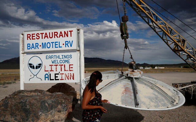 A woman looks at a UFO display outside of the Little A'Le'Inn, in Rachel, Nevada, the closest town to Area 51, July 22, 2019. (AP Photo/John Locher, File) A woman looks at a UFO display outside of the Little A'Le'Inn, in Rachel, Nevada, the closest town to Area 51, July 22, 2019. (AP Photo/John Locher, File)