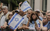 Spectators watch the 2025 Israel Day Parade, on New York's Fifth Avenue, Sunday, May 18, 2025. (AP Photo/Richard Drew)