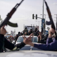 Members of the al-Qassam Brigades, the armed wing of Hamas, take part in a parade as they celebrate a ceasefire agreement between Hamas and Israel in Deir al-Balah, Gaza Strip, on January 19, 2025. (AP Photo/Abdel Kareem Hana, File)