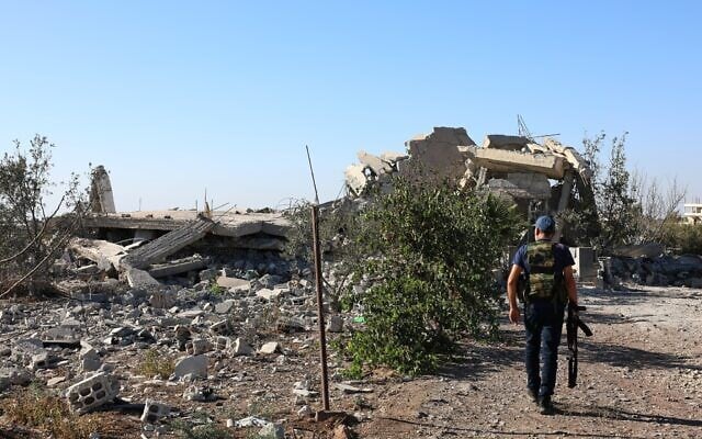 A gunman walks by the remains of a house destroyed during the recent sectarian clashes in the Druze-majority town of Sweida, southern Syria, on September 19, 2025. (AP Photo/Fahd Kiwan) A gunman walks by the remains of a house destroyed during the recent sectarian clashes in the Druze-majority town of Sweida, southern Syria, on September 19, 2025. (AP Photo/Fahd Kiwan)