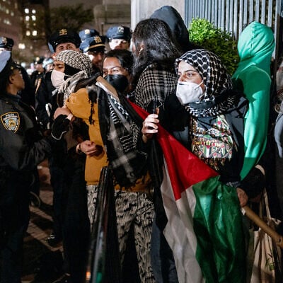 Leqaa Kordia, second from right, demonstrates with pro-Palestianian protesters as they gather near a main gate at Columbia University in New York, April 30, 2024, just before New York City police officers cleared the area after a building was taken over by protesters earlier in the day. (AP Photo/Craig Ruttle)