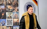 A party member walks in front of a stand during the re-founding of the AfD youth organization as "Generation Deutschland" in Giessen, Germany, November 29, 2025. (Martin Meissner/AP)