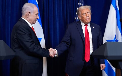 US President Donald Trump (R) shakes hands with Prime Minister Benjamin Netanyahu as Trump listens to a question from a reporter at the end of a news conference at Mar-a-Lago, on December 29, 2025, in Palm Beach, Florida. (AP Photo/Alex Brandon/File)