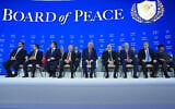 US President Donald Trump, center, poses with international leaders after the signing of a Gaza Board of Peace charter during the Annual Meeting of the World Economic Forum in Davos, Switzerland, January 22, 2026. (AP Photo/Evan Vucci)