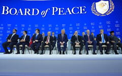 US President Donald Trump, center, poses with international leaders after the signing of a Gaza Board of Peace charter during the Annual Meeting of the World Economic Forum in Davos, Switzerland, January 22, 2026. (AP Photo/Evan Vucci)