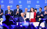 President Donald Trump holds the charter during a signing ceremony on his Board of Peace initiative at the Annual Meeting of the World Economic Forum in Davos, Switzerland, Thursday, Jan. 22, 2026. (AP Photo/Markus Schreiber)