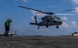 This handout image from the US Navy shows Capt. Daniel Keeler, the commanding officer of the Nimitz-class aircraft carrier USS Abraham Lincoln, flying an MH-60R Sea Hawk helicopter in the Indian Ocean on Jan. 23, 2026. (Mass Communication Specialist Seaman Daniel Kimmelman/US Navy via AP)