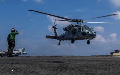 This handout image from the US Navy shows Capt. Daniel Keeler, the commanding officer of the Nimitz-class aircraft carrier USS Abraham Lincoln, flying an MH-60R Sea Hawk helicopter in the Indian Ocean on Jan. 23, 2026. (Mass Communication Specialist Seaman Daniel Kimmelman/US Navy via AP)