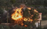 Flames rise from a building that was hit by an Israeli airstrike in Ain Qana, southern Lebanon, February 2, 2026. (AP Photo/Mohammed Zaatari)