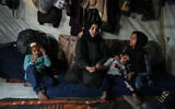 Rotana al-Regeb, who was allowed into Gaza from Egypt following the long-awaited reopening of the Rafah Crossing, reunites with her children in Khan Younis, southern Gaza Strip, February 3, 2026. (AP Photo/Jehad Alshrafi)