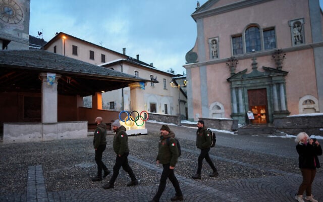 Members of the Italian Army walk past Olympic rings installed in Piazza Cavour, at the 2026 Winter Olympics, in Bormio, Italy, February 5, 2026. (AP Photo/Rebecca Blackwell) Members of the Italian Army walk past Olympic rings installed in Piazza Cavour, at the 2026 Winter Olympics, in Bormio, Italy, February 5, 2026. (AP Photo/Rebecca Blackwell)