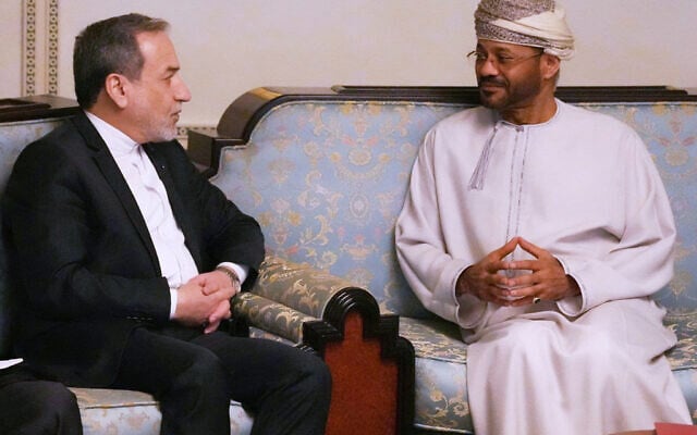 In this photo released by the Iranian Foreign Ministry, Iranian Foreign Minister Abbas Araghchi, left, speaks with his Omani counterpart Sayyid Badr Albusaidi during their meeting prior to Iran and the US negotiations, in Muscat, Oman, February 6, 2026. (Iranian Foreign Ministry via AP)