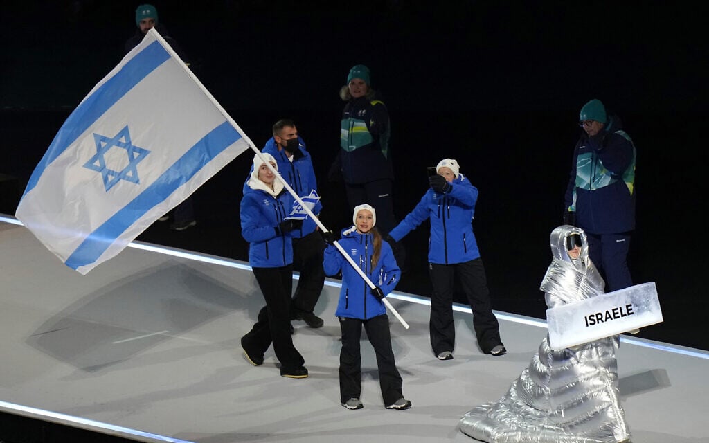 Mariia Seniuk, flag bearer of Israel, walks during the Olympic opening ceremony at the 2026 Winter Olympics, in Milan, Italy, Friday, Feb. 6, 2026. (AP Photo/Francisco Seco)