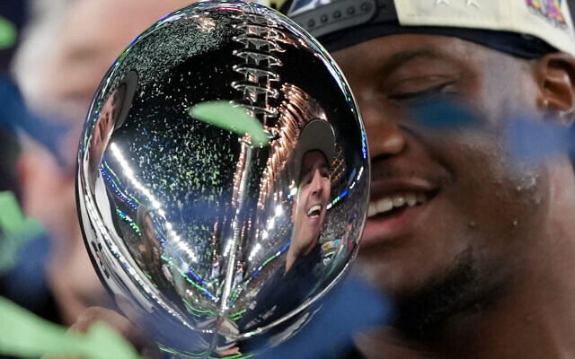 Seattle Seahawks head coach Mike MacDonald is reflected in the Lombardi Trophy after a win over the New England Patriots in the NFL Super Bowl 60 football game in Santa Clara, California, February 8, 2026, (Matt Slocum/AP) Seattle Seahawks head coach Mike MacDonald is reflected in the Lombardi Trophy after a win over the New England Patriots in the NFL Super Bowl 60 football game in Santa Clara, California, February 8, 2026, (Matt Slocum/AP)