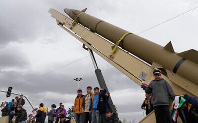 Boys stand on a launcher of an Iranian domestically built missile during an annual rally marking the 1979 Islamic Revolution at Azadi (Freedom) Square in Tehran, Iran, February 11, 2026. (Vahid Salemi/AP)