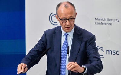 Germany's Chancellor Friedrich Merz prepares to address the audience during the Munich Security Conference in Munich, Germany, Friday, Feb. 13, 2026. (AP Photo/Michael Probst)
