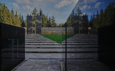 A man walks through a memorial site at the Kaisariani Shooting Range in the Kaisariani suburb of Athens, February 16, 2026, where 200 Greek communist political prisoners were executed by Nazi forces on May 1, 1944. (AP/Petros Giannakouris)
