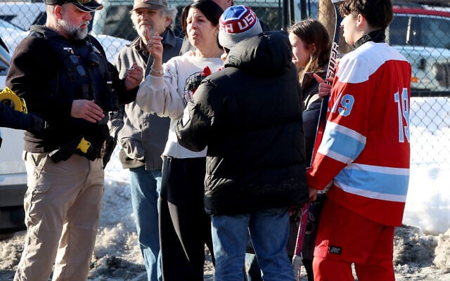 Hockey parents and a player speak to a police officer outside of the Lynch Arena in Pawtucket, Rhode Island, after a shooting at the ice rink on February 16, 2026. (AP Photo/Mark Stockwell) Hockey parents and a player speak to a police officer outside of the Lynch Arena in Pawtucket, Rhode Island, after a shooting at the ice rink on February 16, 2026. (AP Photo/Mark Stockwell)