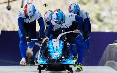 Israel's AJ Edelman, front, Menachem Chen, Uri Zisman and Omer Katz start for a four-man bobsleigh run at the 2026 Winter Olympics, in Cortina d'Ampezzo, Italy, Feb. 21, 2026. (AP/Alessandra Tarantino)