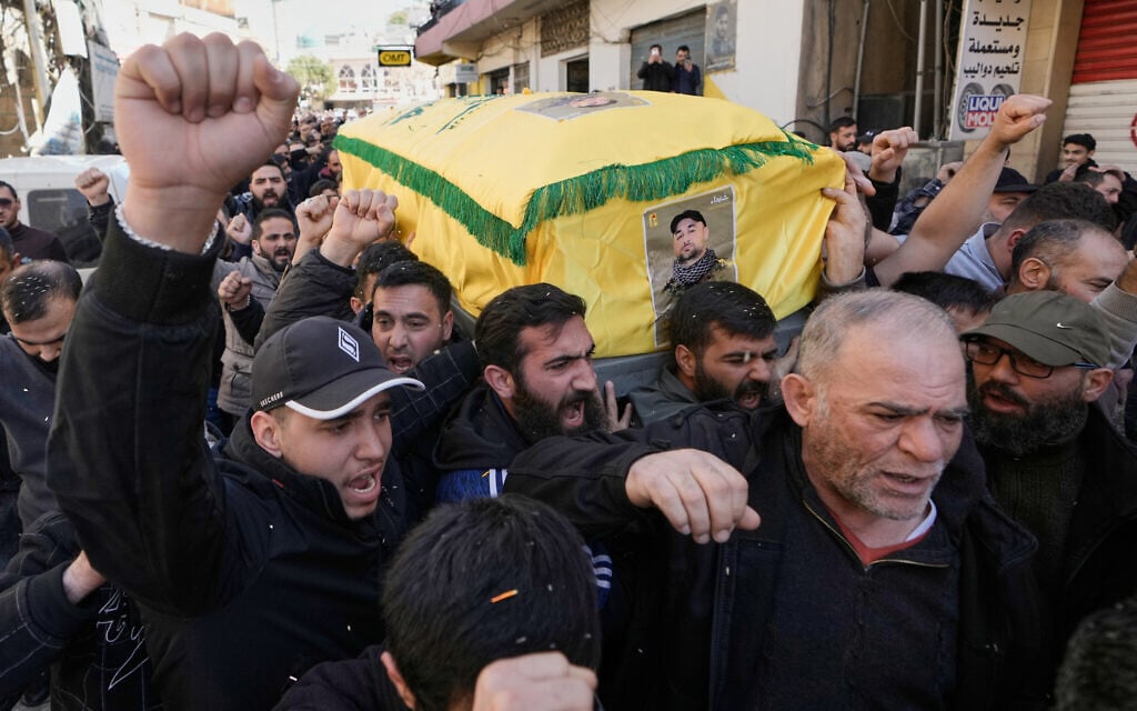 Mourners chant slogans as they carry the coffins of three Hezbollah operatives killed in Israeli strikes during their funeral procession in the village of Nabi Sheet in eastern Lebanon, February 21, 2026. (AP Photo/Bilal Hussein) Mourners chant slogans as they carry the coffins of three Hezbollah operatives killed in Israeli strikes during their funeral procession in the village of Nabi Sheet in eastern Lebanon, February 21, 2026. (AP Photo/Bilal Hussein)