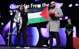 Director Abdallah Al-Khatib, left, and Taqiyeddine Issaad hold a Palestinian flag after receiving the GWFF best first feature award for 'Chronicles from the Siege,' during the awards ceremony for the International Film Festival, Berlinale, in Berlin, Germany, February 21, 2026. (Ebrahim Noroozi/ AP).
