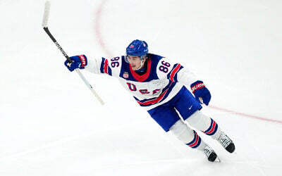 United States' Jack Hughes celebrates after scoring the winning goal against Canada during the overtime period of the men's ice hockey gold medal game at the 2026 Winter Olympics in Milan, Italy, February 22, 2026. (AP Photo/Carolyn Kaster)