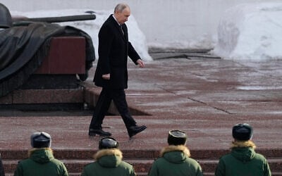 Russian President Vladimir Putin attends a wreath-laying ceremony at the Tomb of the Unknown Soldier, near the Kremlin Wall during the national celebrations of the "Defender of the Fatherland Day" in Moscow, Russia, on Monday, Feb. 23, 2026. (AP Photo/Alexander Zemlianichenko, Pool)