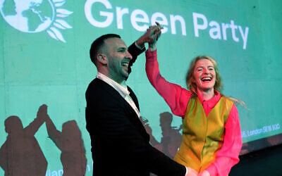 Green Party candidate Hannah Spencer, right, celebrates with party leader Zack Polanski at a volunteer event after winning the Gorton and Denton by-election, Manchester, England, February 27, 2026. (AP/Jon Super)