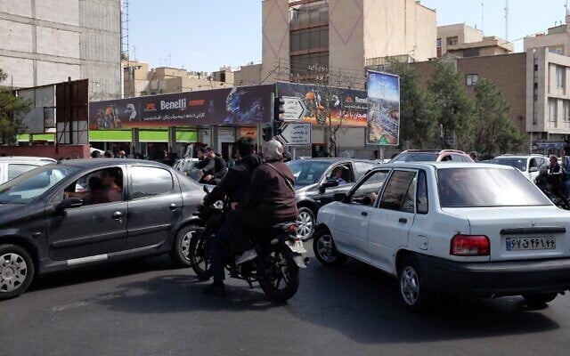 Vehicles cross an intersection following Israeli and US strikes in Tehran, Iran, February 28, 2026. (AP Photo/Vahid Salemi)