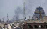 Smoke rises on the skyline after an explosion in Tehran, Iran, February 28, 2026. (AP Photo/Vahid Salemi)