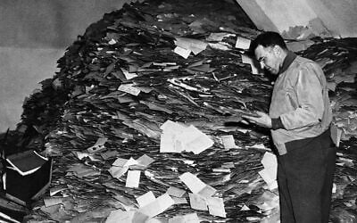 The entire administrative headquarters of the Nazi party have been discovered in Munich, Germany. The bulk of the records, comprising forty tons of documents including twelve million membership and filing cards, were discovered in a paper mill on the outskirts of the town, whilst the remainder were found in the strong room of the Munich party headquarters, and stored in four different offices in the city.  Major William D. Browne, Security Officer, and former detective who was instrumental in making the discovery of the Nazi Party master files, inspects the huge pile of cards in the Munich paper mills, on Oct. 28, 1945. (AP Photo)