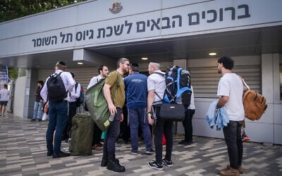 Illustrative: Orthodox men arrive at the IDF recruiting offices in Tel Hashomer, near Tel Aviv, October 23, 2023. (Avshalom Sassoni/Flash90)