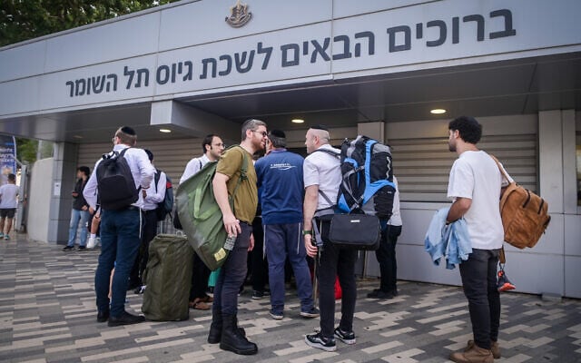 Illustrative: Orthodox men arrive at the IDF recruiting offices in Tel Hashomer, near Tel Aviv, October 23, 2023. (Avshalom Sassoni/Flash90) Illustrative: Orthodox men arrive at the IDF recruiting offices in Tel Hashomer, near Tel Aviv, October 23, 2023. (Avshalom Sassoni/Flash90)