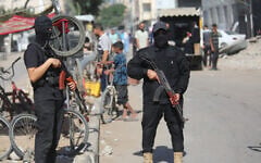 Armed Hamas police officers patrol in Gaza City, October 11, 2025. (Ali Hassan/Flash90)