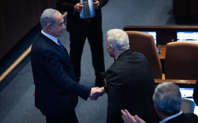 Prime Minister Benjamin Netanyahu (L) with Opposition Leader Yair Lapid at the Knesset, in Jerusalem, January 26, 2026. (Yonatan Sindel/Flash90)