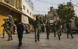 Illustrative: IDF soldiers guard a tour of the West Bank city of Hebron, on February 14, 2026. (Wisam Hashlamoun/Flash90)