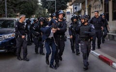 An ultra-Orthodox man is arrested by police during riots following an assault on two female Israeli soldiers in Bnei Brak, central Israel, February 15, 2026. (Flash90)
