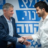 The Democrats party leader Yair Golan (left) shakes hands with new member Omri Ronen at a faction meeting at the Knesset in Jerusalem, February 16, 2026. (Yonatan Sindel/Flash90)