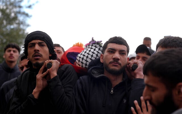 Mourners carry the body of Palestinian-American Nasrallah Muhammad Abu Siam, 19, who was allegedly shot by settlers, during his funeral in the West Bank village of Mukhmas, east of Ramallah, February 19, 2026. (Flash90) Mourners carry the body of Palestinian-American Nasrallah Muhammad Abu Siam, 19, who was allegedly shot by settlers, during his funeral in the West Bank village of Mukhmas, east of Ramallah, February 19, 2026. (Flash90)