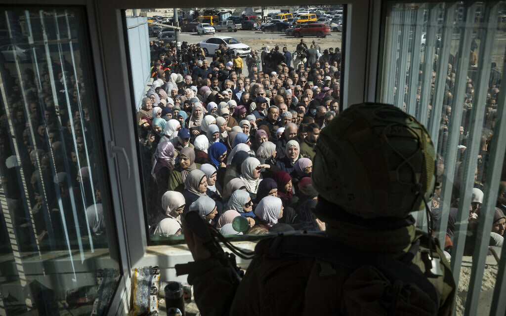 Israeli security forces stand guard as Palestinians pass through the Qalandia checkpoint on their way to attend the first Friday prayers of Ramadan at Jerusalem’s Al-Aqsa compound on the Temple Mount, February 20, 2026 (Chaim Goldberg/Flash90) Israeli security forces stand guard as Palestinians pass through the Qalandia checkpoint on their way to attend the first Friday prayers of Ramadan at Jerusalem’s Al-Aqsa compound on the Temple Mount, February 20, 2026 (Chaim Goldberg/Flash90)